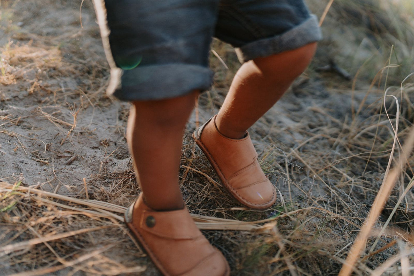 Close-up of child walking in Common Tread Evergreen shoes showing flexible sole