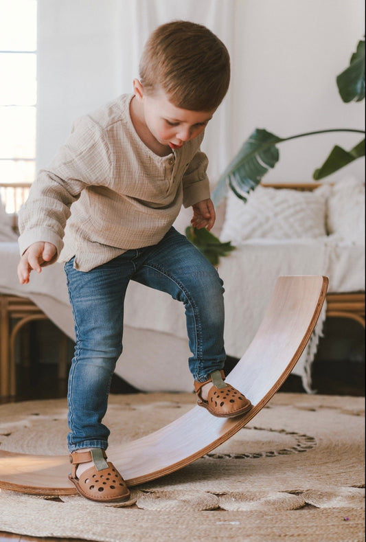 child playing in barefoot sandals 