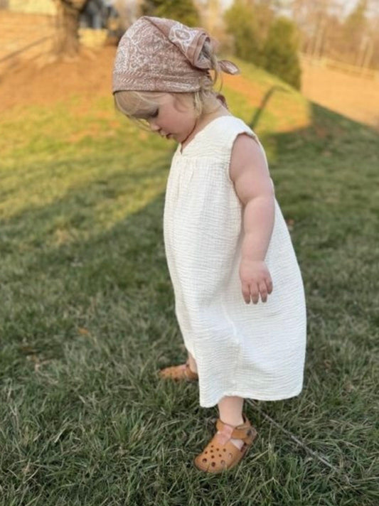 Toddler wearing kids barefoot shoes with a wide toe box playing outdoors