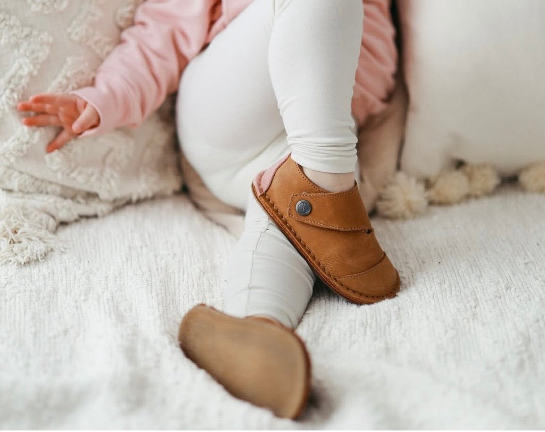 Child wearing barefoot shoes for kids balancing naturally outdoors to support healthy foot development, posture, and strong arches.