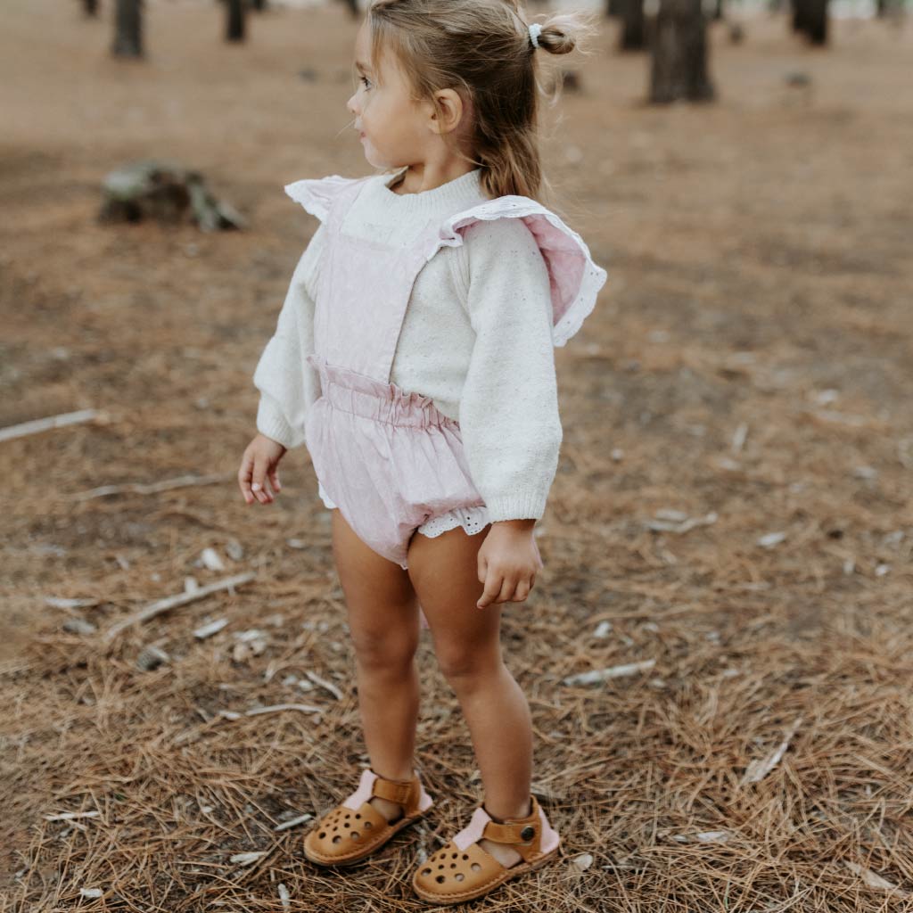 Child wearing Amber Desert barefoot sandals standing outdoors