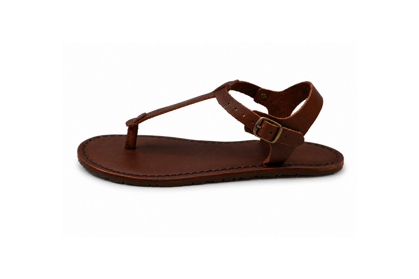 Side profile of the Sierra women’s barefoot sandal by Common Tread showing thin flexible sole and minimalist leather T-bar silhouette