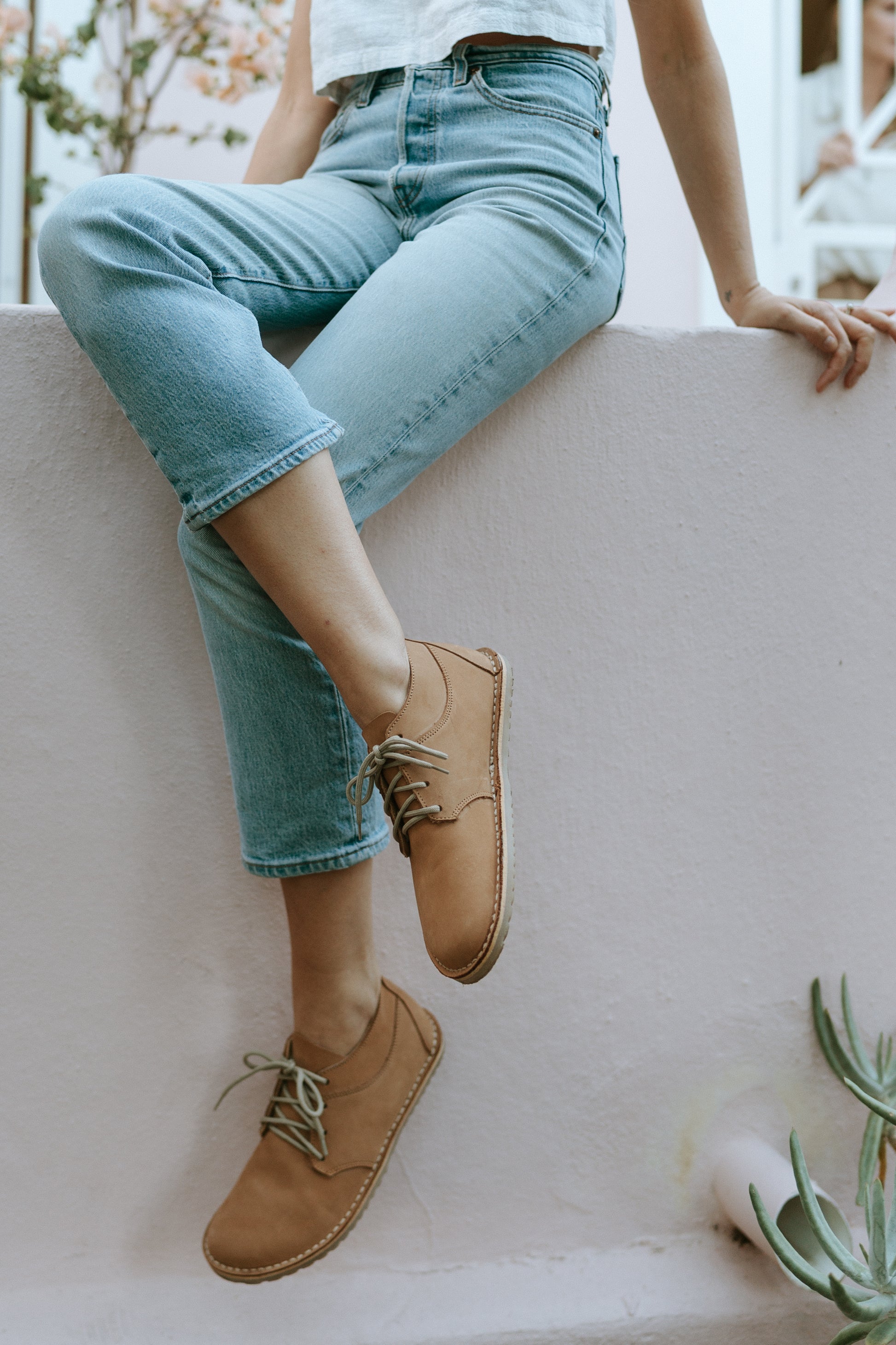 Woman wearing the Common Tread Tundra women’s barefoot leather shoe with jeans in an everyday lifestyle setting