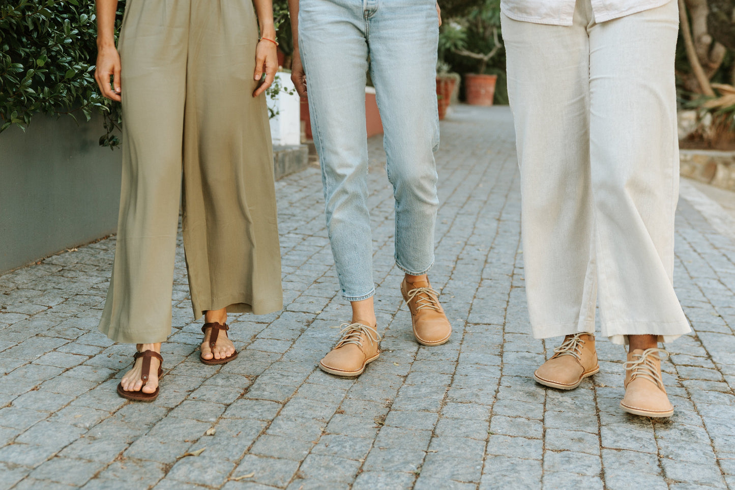 Women walking outdoors wearing Common Tread barefoot footwear including the women’s Tundra shoe