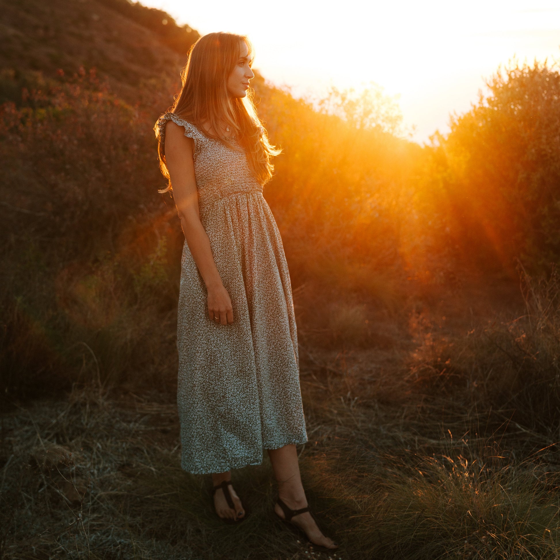 Woman wearing Sierra women’s leather barefoot sandals outdoors in golden light
